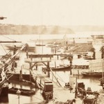 The dilapidated Marine Board ‘government’ boatsheds on the eastern side of Circular Quay, with Fort Macquarie in the distance (Mitchell Library, State Library of NSW - DL PXX 73/21-36)